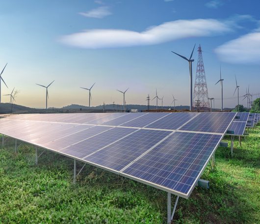 renewable-energy-solar-panels-wind-turbines-green-grass-blue-sky renewable-energy-solar-panels-wind-turbines-green-grass-blue-sky